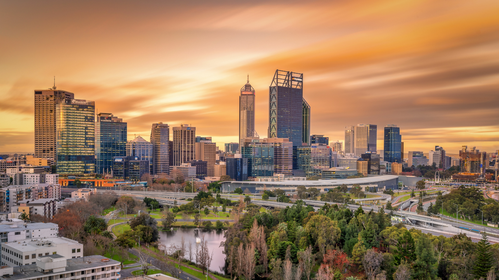 Golden hued sky at sunset with the city scape of Perth